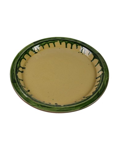 Safata d'argila rodona, de color groc decorada, parament de taula, tradició artesanal.